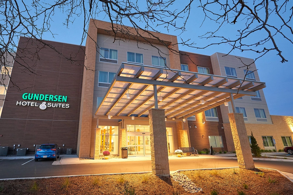 Premier Hotel Properties - Gundersen Hotel & Suites building entrance at dusk in La Crosse, Wisconsin.